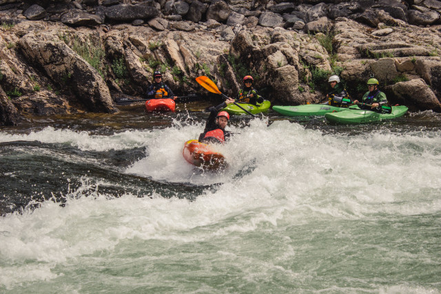 Kayakers surfing on a wave on the MIddle Fork of the Salmon River