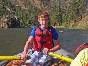 Trey rowing a boat on the Middle Fork